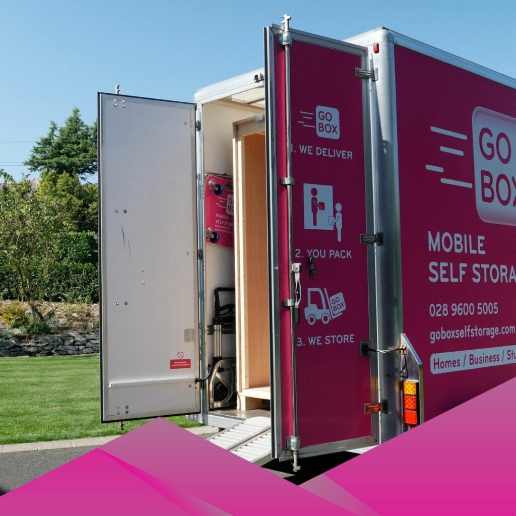 Mobile self-storage unit with open door parked on a driveway, perfect for staying organised while renovating.