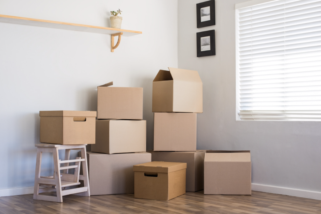 A stack of brown cardboard boxes in a room suggesting a moving process.