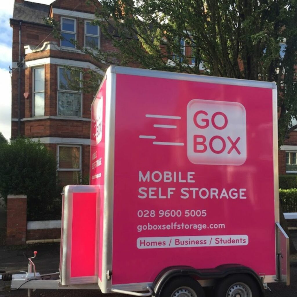 A pink mobile self-storage unit labeled 