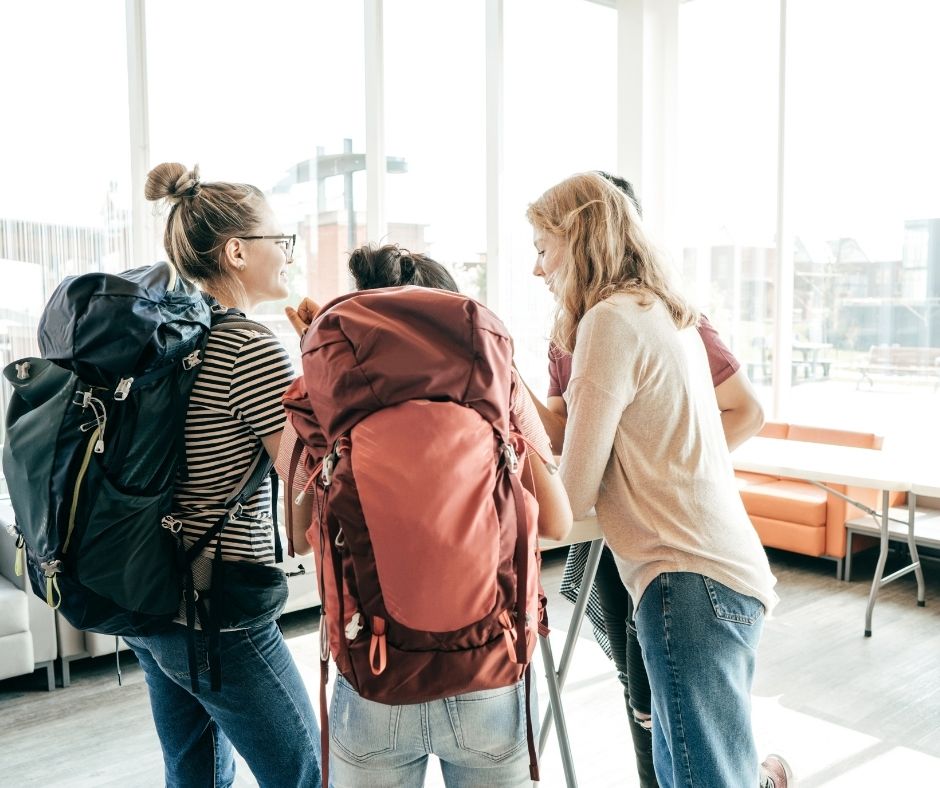 Group of backpackers checking in at a hostel.