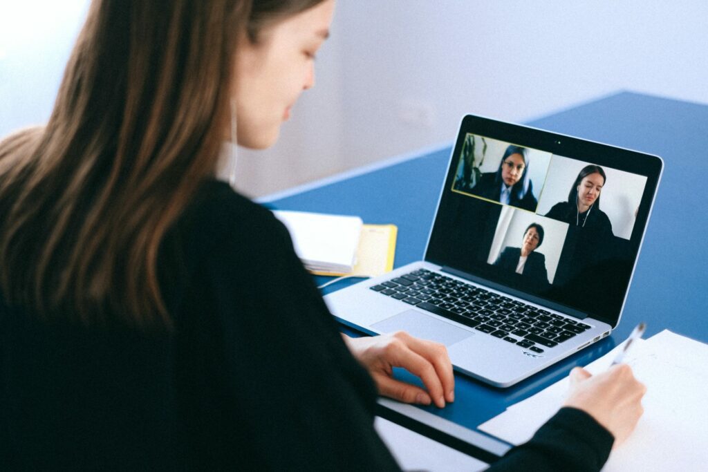 A person attending a video conference call on a laptop.
