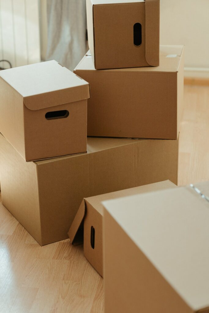 Cardboard boxes in a sunlit room, suggesting a move or the process of packing/unpacking.