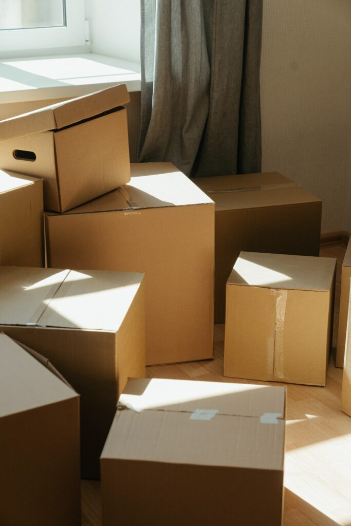 Cardboard boxes in a sunlit room, suggesting a move or the process of packing/unpacking.