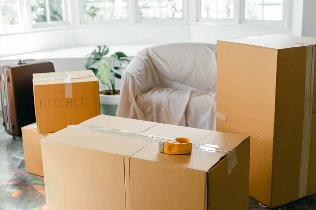 Moving day with packed boxes and furniture in a bright room.