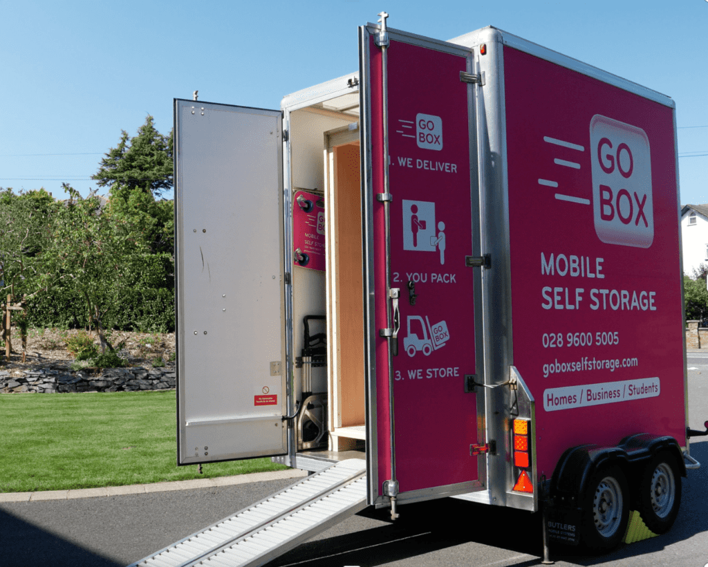 A mobile self-storage unit from go box parked with its door open, ready for loading.